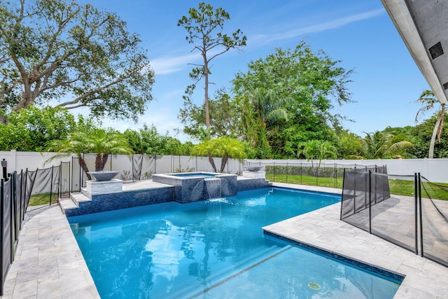 view of pool featuring an in ground hot tub, pool water feature, and a patio