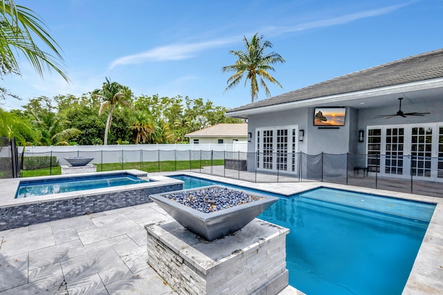 view of swimming pool featuring an in ground hot tub, french doors, ceiling fan, and a patio