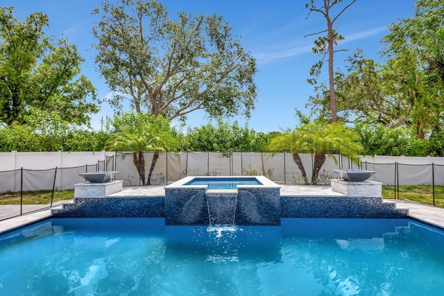 view of pool featuring an in ground hot tub