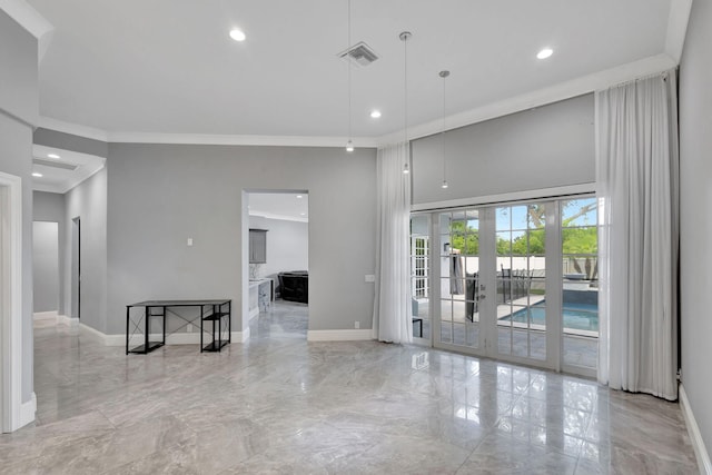 empty room featuring ornamental molding and french doors