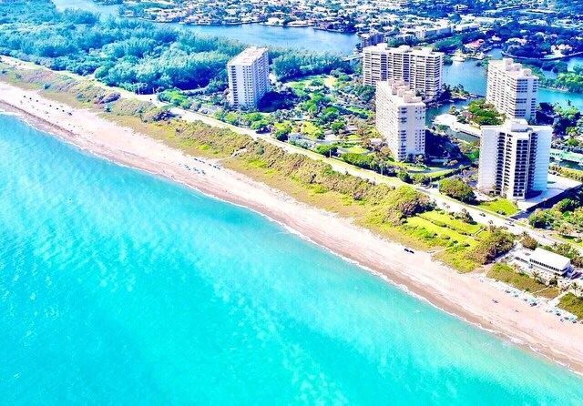 birds eye view of property featuring a view of the beach and a water view