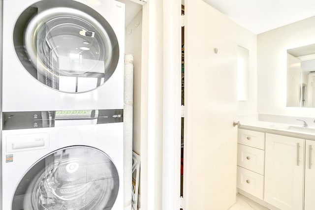 laundry area with sink and stacked washing maching and dryer