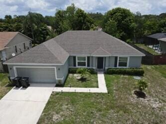 view of front of home with a front yard and a garage