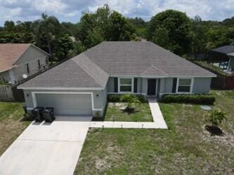 view of front of property with a front yard and a garage