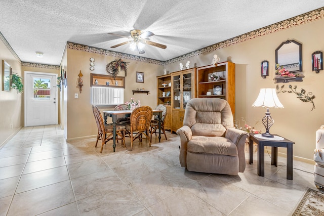 dining space with a textured ceiling and ceiling fan