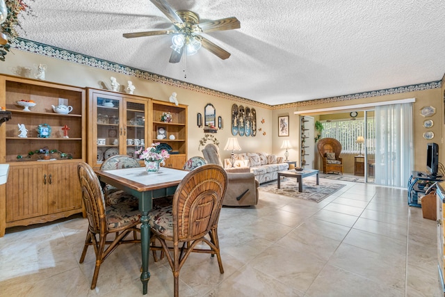 dining space with a textured ceiling and ceiling fan