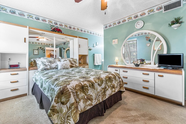 carpeted bedroom featuring a textured ceiling and ceiling fan