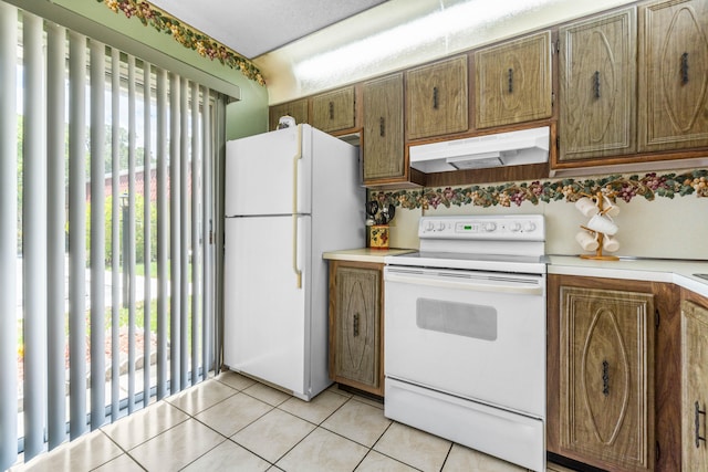 kitchen with white appliances and light tile patterned floors