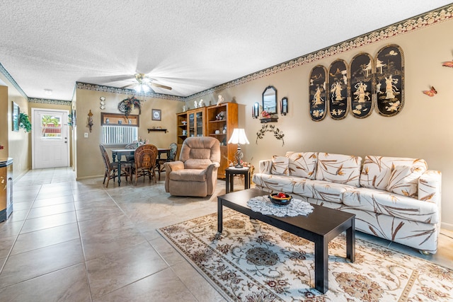 living room with a textured ceiling and ceiling fan