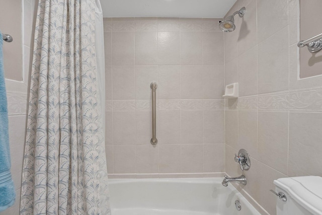 bathroom featuring shower / bathtub combination with curtain and toilet