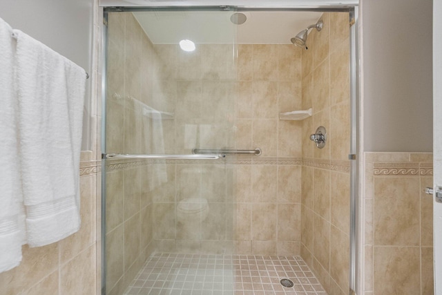 bathroom featuring a shower with shower door