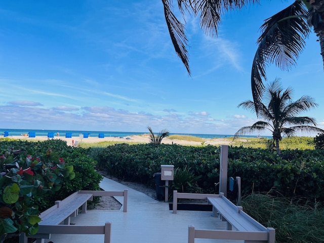 exterior space featuring a beach view and a water view