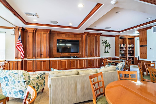 tiled living room featuring ornamental molding, a tray ceiling, and decorative columns