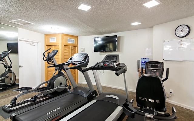 workout area featuring a textured ceiling