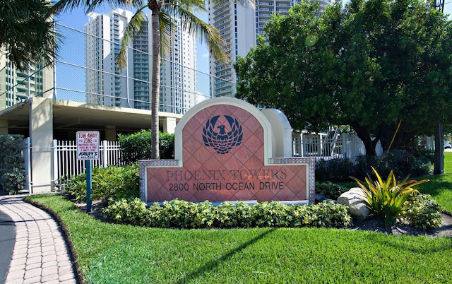 community sign featuring a lawn