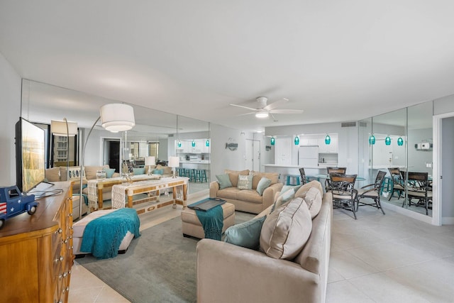 living room with light tile patterned flooring and ceiling fan