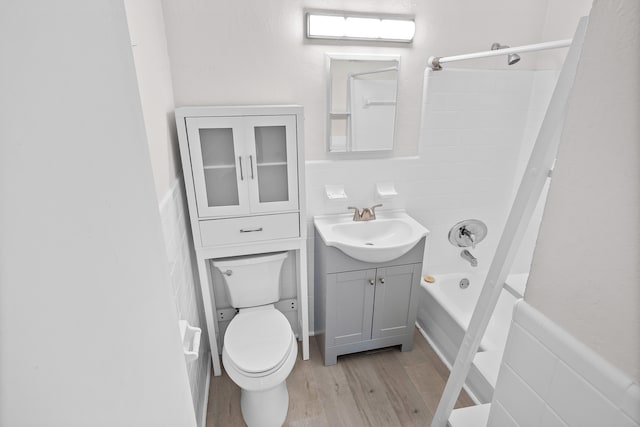 full bathroom featuring shower / washtub combination, hardwood / wood-style floors, vanity, and toilet