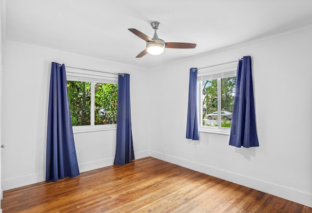 unfurnished room with hardwood / wood-style flooring, plenty of natural light, crown molding, and ceiling fan