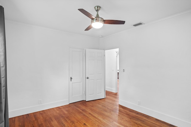 unfurnished bedroom with ceiling fan, light wood-type flooring, and crown molding