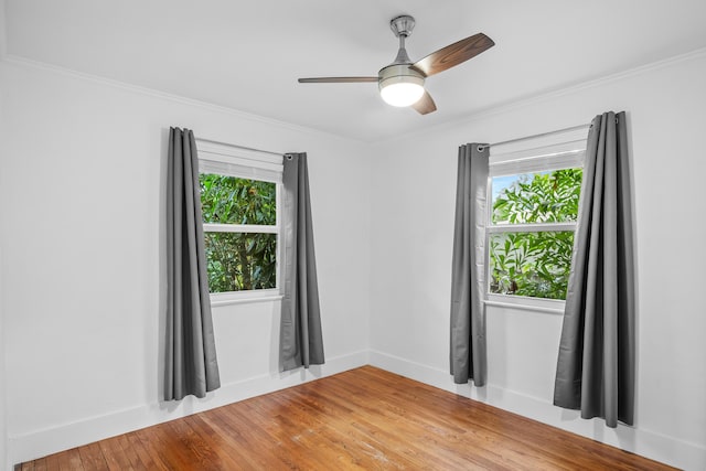 spare room with wood-type flooring, ceiling fan, and crown molding