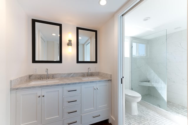 bathroom featuring tiled shower, tile flooring, toilet, and dual bowl vanity