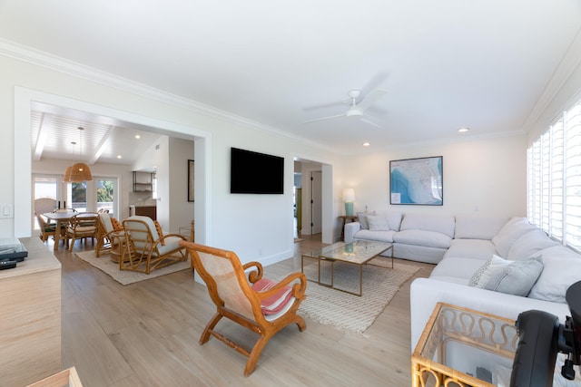 living room featuring light hardwood / wood-style floors, ornamental molding, ceiling fan, and vaulted ceiling