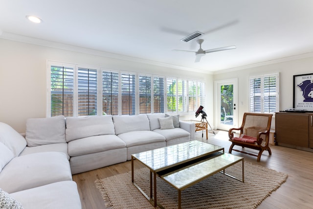 living room with light wood-type flooring, crown molding, plenty of natural light, and ceiling fan