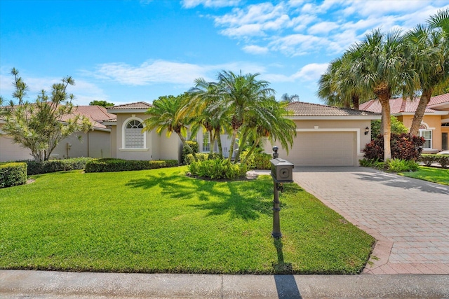 mediterranean / spanish house featuring a front lawn and a garage