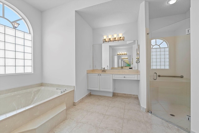 bathroom featuring tile patterned flooring, vanity, a textured ceiling, and shower with separate bathtub