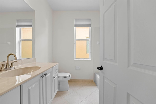 bathroom with tile patterned flooring, vanity, toilet, and plenty of natural light