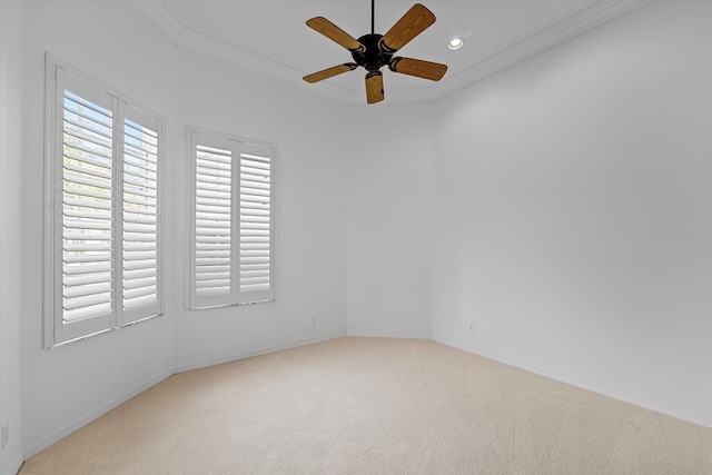 empty room with carpet floors, ceiling fan, and crown molding