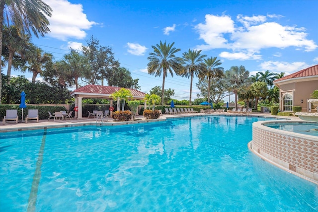 view of pool with a gazebo, a patio area, and a hot tub