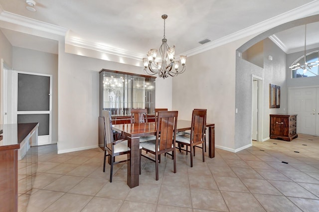 tiled dining room with ornamental molding and an inviting chandelier