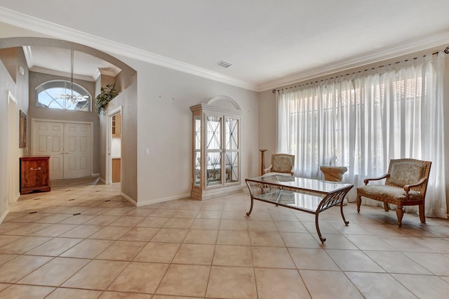 tiled entryway featuring a wealth of natural light and crown molding