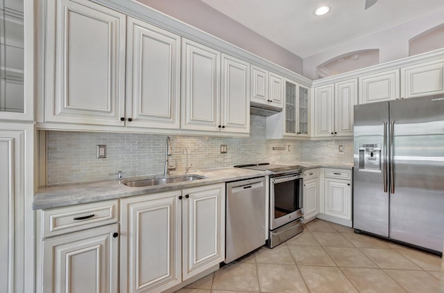 kitchen featuring white cabinetry, sink, light tile patterned flooring, and appliances with stainless steel finishes