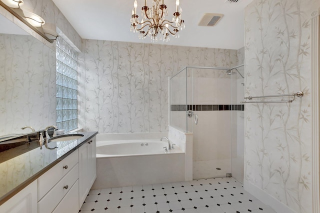 bathroom featuring separate shower and tub, vanity, and a notable chandelier