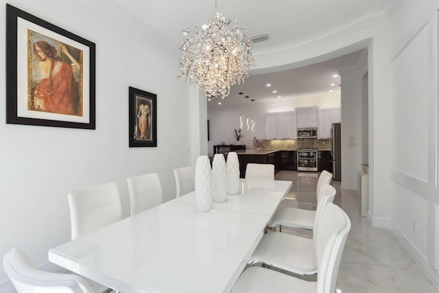 dining area featuring an inviting chandelier and ornamental molding