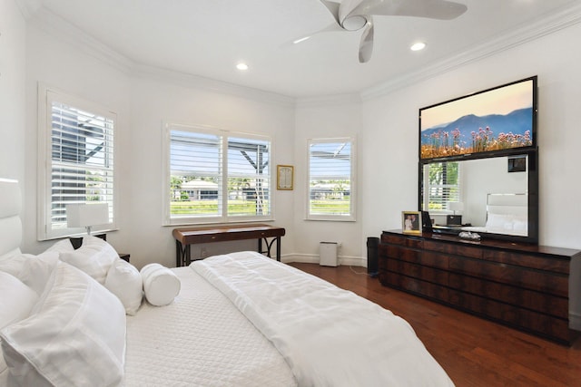 bedroom featuring dark hardwood / wood-style flooring, multiple windows, ceiling fan, and ornamental molding