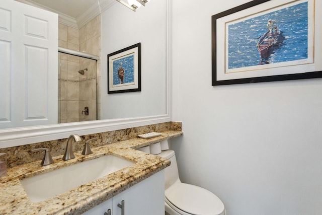 bathroom with toilet, crown molding, walk in shower, and vanity