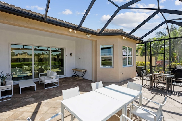 view of patio featuring a lanai