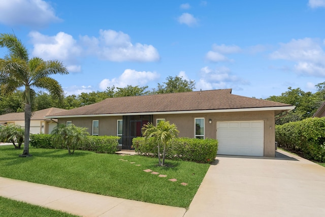 single story home featuring a front lawn and a garage