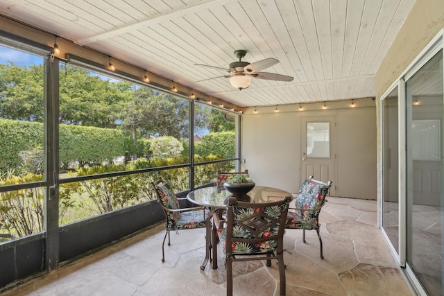 sunroom / solarium with ceiling fan, wooden ceiling, and track lighting