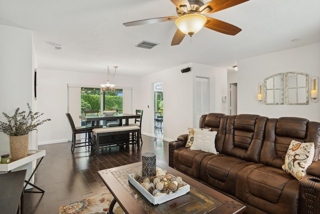 living room featuring ceiling fan with notable chandelier