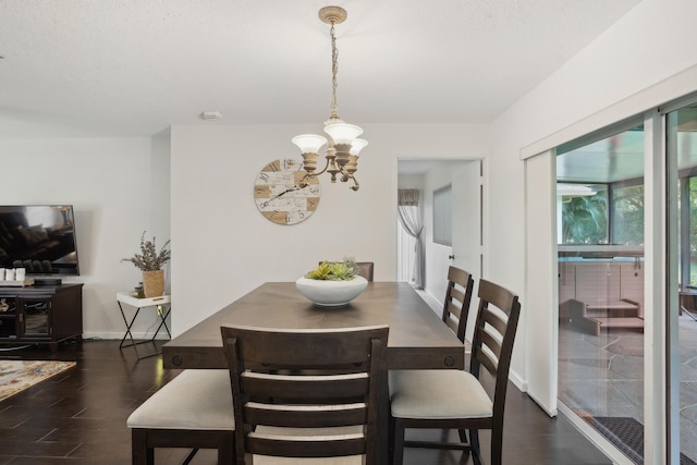 dining room with an inviting chandelier and dark wood-type flooring