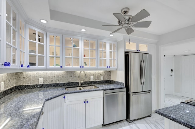 kitchen with dark stone countertops, sink, white cabinets, and appliances with stainless steel finishes