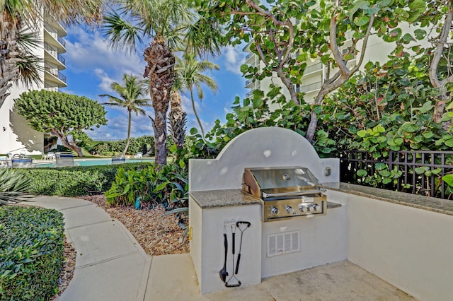 view of patio / terrace featuring a grill and exterior kitchen