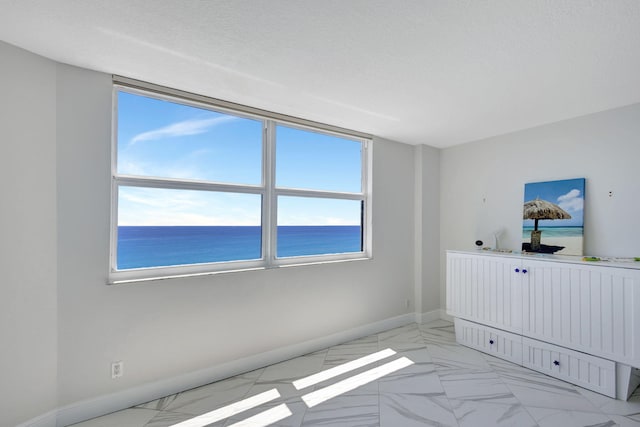 unfurnished bedroom with a water view and multiple windows