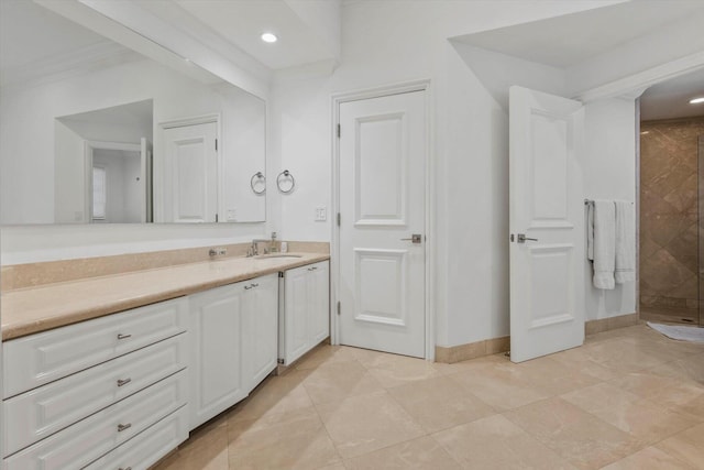 bathroom with a tile shower, crown molding, tile patterned floors, and vanity