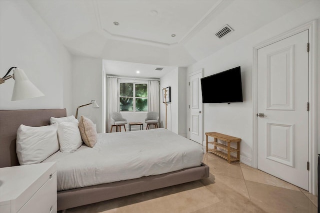 tiled bedroom with a tray ceiling and ornamental molding