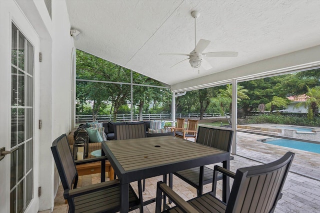 sunroom with ceiling fan and lofted ceiling